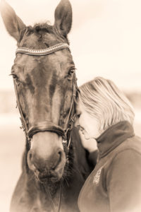 young woman is standing beside a horse young woman is standing beside a horse